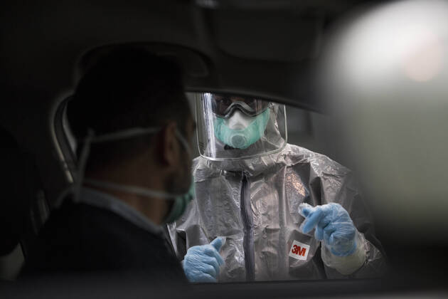 April 15, 2020, Granada, Spain: A health worker in a protective suit takes a sample for a PCR test..During the coronavirus crisis, at the ITV (technical inspection of vehicles) center in Albolote PCR tests (polymerase chain reaction) are carried out on workers of the security forces and staff of nursing homes to detect Covid 19. Granada Spain - ZUMAs197 20200415_zaa_s197_099 Copyright: xCarlosxGilx