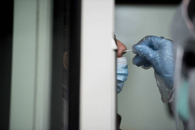 April 15, 2020, Granada, Spain: A health worker in a protective suit takes a sample for a PCR test..During the coronavirus crisis, at the ITV (technical inspection of vehicles) center in Albolote PCR tests (polymerase chain reaction) are carried out on workers of the security forces and staff of nursing homes to detect Covid 19. Granada Spain - ZUMAs197 20200415_zaa_s197_107 Copyright: xCarlosxGilx