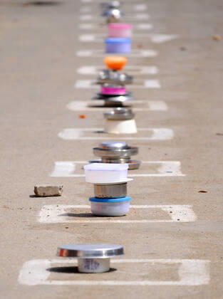 CHANDIGARH, INDIA - APRIL 15: People keep their utensils in the marked boxes as they wait at a food distribution during lockdown against Coronavirus, at a slum, in Industrial area Phase 1 on April 15, 2020 in Chandigarh, India. (Photo by Anil Dayal Hindustan Times) Government Provide Food To Homeless And Poor Amid Lockdown To Prevent Covid-19
