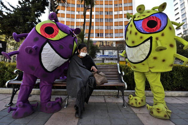 April 15, 2020, La Paz, LA PAZ, Bolivia: The Bolivian Police take to the streets of La Paz two characters representing the COVID-19 virus for a work to raise awareness among the population, among others regarding the use of masks and respect for safety distances. They sit in the rows for the benches, or in the public seats, they persecute those who do not have masks, among others La Paz Bolivia - ZUMAl72_ 20200415_znp_l72_004 Copyright: xChristianxLombardix
