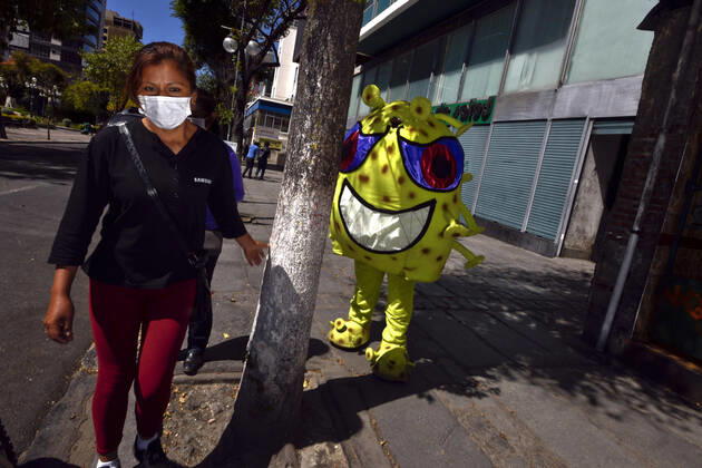April 15, 2020, La Paz, LA PAZ, Bolivia: The Bolivian Police take to the streets of La Paz two characters representing the COVID-19 virus for a work to raise awareness among the population, among others regarding the use of masks and respect for safety distances. They sit in the rows for the benches, or in the public seats, they persecute those who do not have masks, among others La Paz Bolivia - ZUMAl72_ 20200415_znp_l72_005 Copyright: xChristianxLombardix