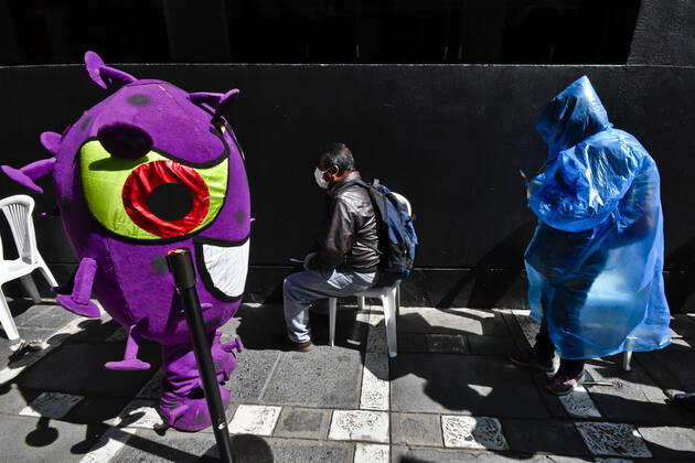 April 15, 2020, La Paz, LA PAZ, Bolivia: The Bolivian Police take to the streets of La Paz two characters representing the COVID-19 virus for a work to raise awareness among the population, among others regarding the use of masks and respect for safety distances. They sit in the rows for the benches, or in the public seats, they persecute those who do not have masks, among others La Paz Bolivia - ZUMAl72_ 20200415_znp_l72_009 Copyright: xChristianxLombardix