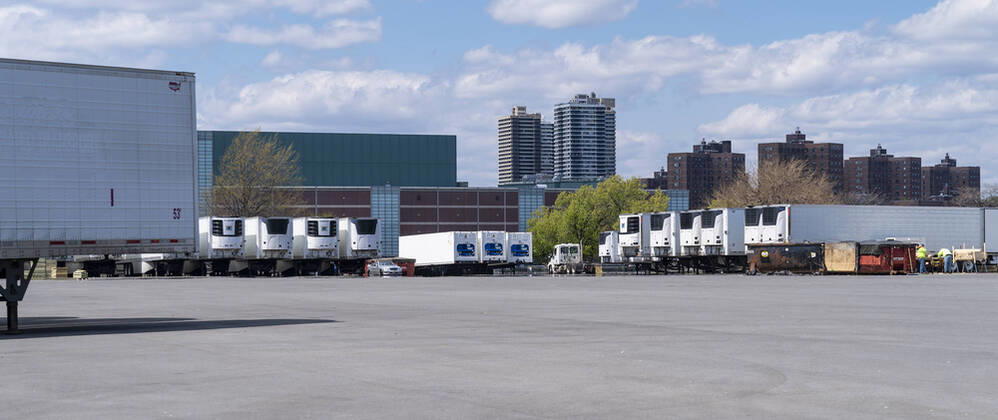Live in New York amid COVID-19 epidemic Dozens of refrigerated trucks and containers seen on Randall s Island prepared for influx of dead bodies as makeshift morgues amid COVID-19 pandemic New York New York United States Copyright: LevxRadin