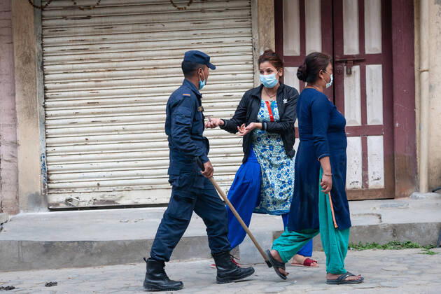 Nepal: 23rd day Nationwide lockdown amid COVID-19 Police personnel using batons to disperse crowd gathered in relief food distribution camp in Kathmandu, Nepal on Wednesday, 15 April 2020. Government has imposed lockdown in order to control covid 19 transmission but as large number of people were gathered in the camp police use force to disperse the crowd. Kathmandu Nepal Copyright: PrabinxRanabhat