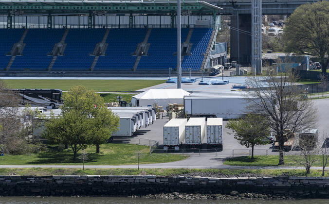 Live in New York amid COVID-19 epidemic Dozens of refrigerated trucks and containers seen on Randall s Island prepared for influx of dead bodies as makeshift morgues amid COVID-19 pandemic New York New York United States Copyright: LevxRadin