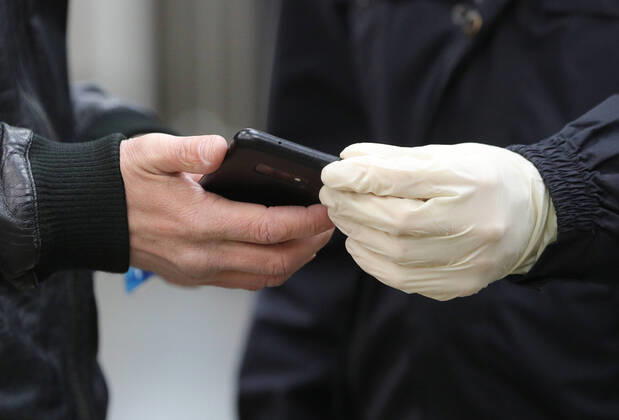 MOSCOW, RUSSIA - APRIL 16, 2020: A police officer checks a digital pass code for traveling across the city at Rechnoi Vokzal Station of the Moscow Metro amid the self-isolation regime. Sergei Bobylev TASS  TS0D5EC5