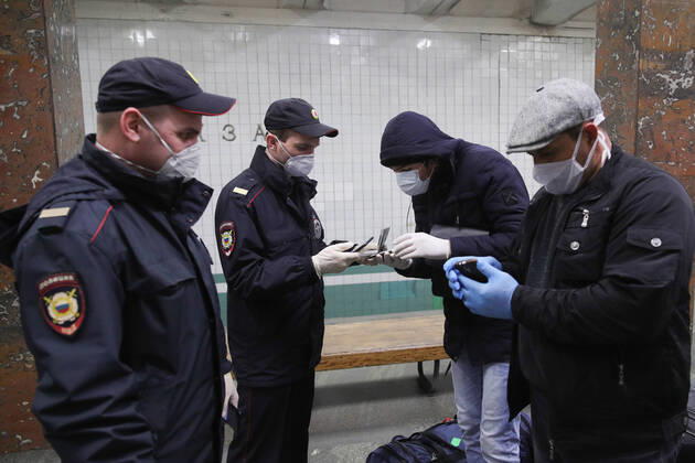 MOSCOW, RUSSIA - APRIL 16, 2020: Police officers check digital pass codes for traveling across the city at Rechnoi Vokzal Station of the Moscow Metro amid the self-isolation regime. Sergei Bobylev TASS  TS0D5ED4