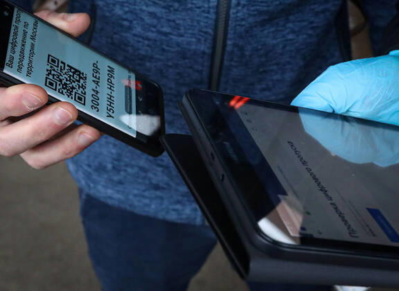 MOSCOW, RUSSIA - APRIL 16, 2020: A police officer checks a digital pass code for traveling across the city at Vykhino Station of the Moscow Metro amid the self-isolation regime. Stanislav Krasilnikov TASS  TS0D5EED