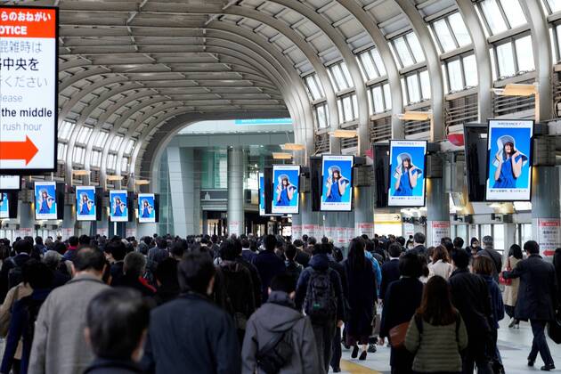 People walk through a train station during the morning rush hour in Tokyo, Japan on April 16, 2020, amid the state of emergency due to the spread of the novel coronavirus.  (125388347)