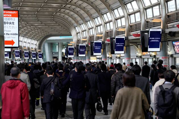 People walk through a train station during the morning rush hour in Tokyo, Japan on April 16, 2020, amid the state of emergency due to the spread of the novel coronavirus.  (125388350)