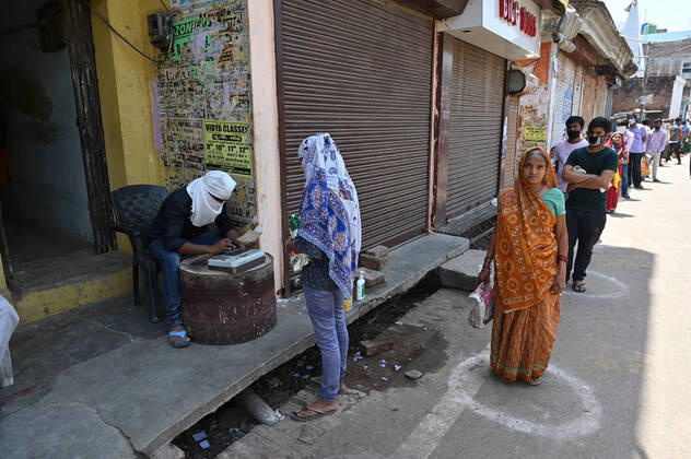April 16, 2020, Prayagraj, Uttar Pradesh, India: Prayagraj: People maintain social distance during in a queue to take free ration at a government storeduring a nationwide lockdown imposed as a preventive measure against the spread of the COVID-19 coronavirus in Allahabad Prayagraj India - ZUMAv115 20200416_zap_v115_005 Copyright: xPrabhatxKumarxVermax