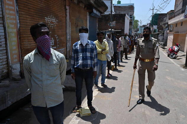 April 16, 2020, Prayagraj, Uttar Pradesh, India: Prayagraj: People maintain social distance during in a queue to take free ration at a government storeduring a nationwide lockdown imposed as a preventive measure against the spread of the COVID-19 coronavirus in Allahabad Prayagraj India - ZUMAv115 20200416_zap_v115_010 Copyright: xPrabhatxKumarxVermax