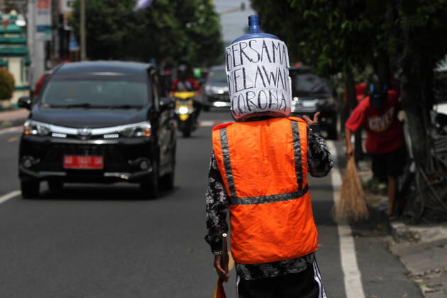 Wearing Gallons for Face Shield amid the spread of COVID-19 in Indonesia - 16 April 2020. A traffic control volunteer wearing unique face shields from used gallons in Yogyakarta, Wednesday, April 16, 2020. Ali Akbar (52) wearing unique face shield when managing traffic amid the spread of Coronavirus (COVID-19) disease. (Photo by Devi Rahman INA Photo Agency imago images) 
