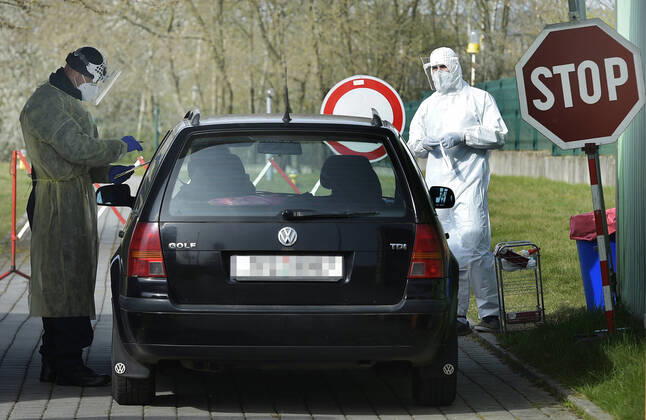 Paramedics take samples for covid-19 tests in drive-through testing station near the Domazlice Hospital, Czech Republic, on Wednesday, April 15, 2020. (CTKxPhoto MiroslavxChaloupka) CTKPhotoP202004150450701 cha001