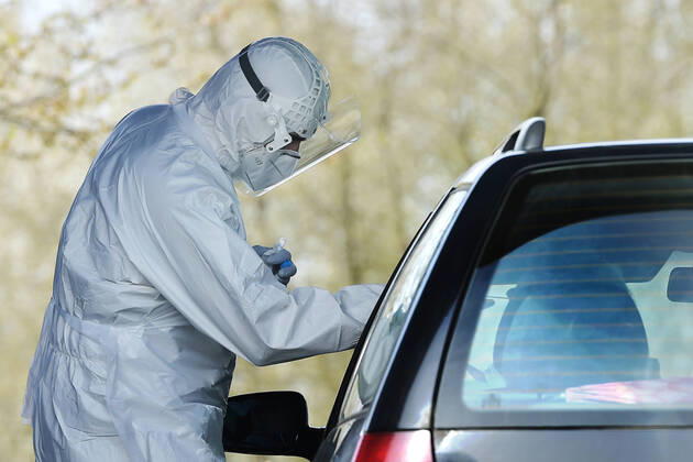 Paramedics take samples for covid-19 tests in drive-through testing station near the Domazlice Hospital, Czech Republic, on Wednesday, April 15, 2020. (CTKxPhoto MiroslavxChaloupka) CTKPhotoP202004150452901 cha007