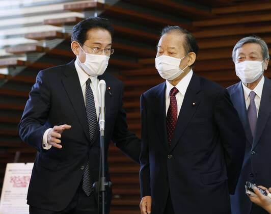 New coronavirus Japanese Liberal Democratic Party Secretary General Toshiro Nikai (C) and LDP policy chief Fumio Kishida (L) meet the press at the prime minister s office in Tokyo on April 16, 2020, after holding talks with Prime Minister Shinzo Abe over the proposed delivery of 100,000 yen in cash to all citizens to help them weather the fallout from the coronavirus pandemic. 