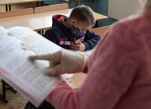 PRIMORYE TERRITORY, RUSSIA - APRIL 16, 2020: A pupil listens to his literature teacher at No 8 Comprehensive School in the village of Nezhino, some 40 km north of Vladivostok. After moving to online schooling due to the COVID-19 pandemic, educational institutions in the Primorye Territory are switching back to classroom teaching, with underfilled schools being the first to welcome pupils. Yuri Smityuk TASS  TS0D5F1D