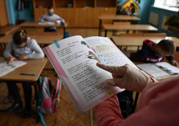 PRIMORYE TERRITORY, RUSSIA - APRIL 16, 2020: A literature teacher reads a story to pupils at No 8 Comprehensive School in the village of Nezhino, some 40 km north of Vladivostok. After moving to online schooling due to the COVID-19 pandemic, educational institutions in the Primorye Territory are switching back to classroom teaching, with underfilled schools being the first to welcome pupils. Yuri Smityuk TASS  TS0D5F1E