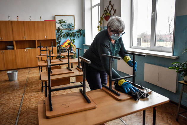 PRIMORYE TERRITORY, RUSSIA - APRIL 16, 2020: A school worker washes chairs and desks with disinfectant at No 8 Comprehensive School in the village of Nezhino, some 40 km north of Vladivostok. After moving to online schooling due to the COVID-19 pandemic, educational institutions in the Primorye Territory are switching back to classroom teaching, with underfilled schools being the first to welcome pupils. Yuri Smityuk TASS  TS0D5F2B