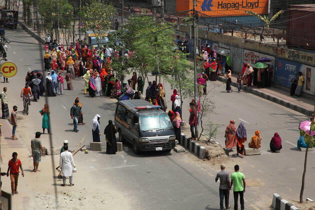 April 16, 2020: An ambulance carrying a patient by breaking the barrier of movement, while female garment workers demonstrate to demand for due wages in front of their factory in South Kamlapur, Dhaka, Bangladesh; during the nationwide lockdown of the coronavirus (Covid-19) pandemic. Their garment factory had been closed for a period of time since 25, March2020 for their health issue due to the coronavirus pandemic. - ZUMAa186 20200416_zip_a186_002 Copyright: xShafayetxHossainxApollox