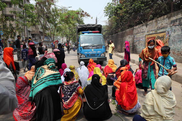 April 16, 2020: Female garment workers halt a police truck by sitting on road and they do not allow to go, while they demonstrate to demand for due wages in front of their factory in South Kamlapur, Dhaka, Bangladesh; during the nationwide lockdown of the coronavirus (Covid-19) pandemic. Their garment factory had been closed for a period of time since 25, March2020 for their health issue due to the coronavirus pandemic. - ZUMAa186 20200416_zip_a186_003 Copyright: xShafayetxHossainxApollox