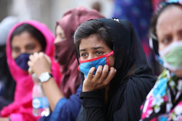 April 16, 2020: Worried female garment workers are sitting on footpath in front of their factory gate, while they demonstrate to demand for due wages in South Kamlapur, Dhaka, Bangladesh; during the nationwide lockdown of the coronavirus (Covid-19) pandemic. Their garment factory had been closed for a period of time since 25, March2020 for their health issue due to the coronavirus pandemic. - ZUMAa186 20200416_zip_a186_006 Copyright: xShafayetxHossainxApollox