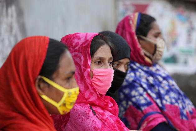 April 16, 2020: Worried female garment workers are sitting on footpath in front of their factory gate, while they demonstrate to demand for due wages in South Kamlapur, Dhaka, Bangladesh; during the nationwide lockdown of the coronavirus (Covid-19) pandemic. Their garment factory had been closed for a period of time since 25, March2020 for their health issue due to the coronavirus pandemic. - ZUMAa186 20200416_zip_a186_007 Copyright: xShafayetxHossainxApollox