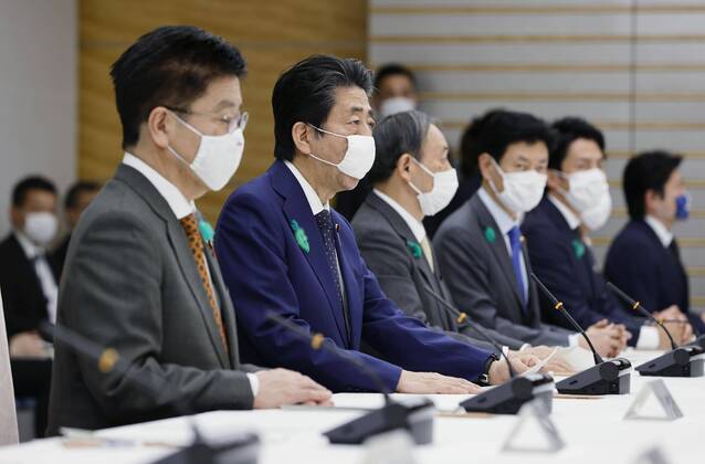 Nationwide state of emergency over coronavirus Japanese Prime Minister Shinzo Abe (2nd from L) declares a nationwide state of emergency in response to a surge in coronavirus infections at a meeting of the government task force on combating the virus in Tokyo on April 16, 2020. 