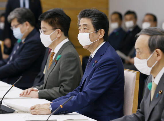 Nationwide state of emergency over coronavirus Japanese Prime Minister Shinzo Abe (2nd from R) declares a nationwide state of emergency in response to a surge in coronavirus infections at a meeting of the government task force on combating the virus in Tokyo on April 16, 2020. 