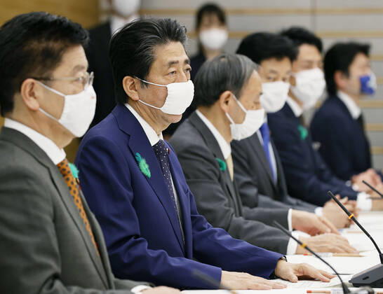 Nationwide state of emergency over coronavirus Japanese Prime Minister Shinzo Abe (2nd from L) declares a nationwide state of emergency in response to a surge in coronavirus infections at a meeting of the government task force on combating the virus in Tokyo on April 16, 2020. 