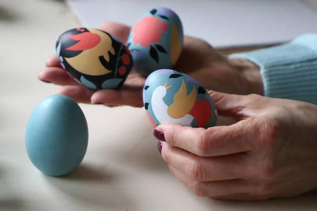 MOSCOW, RUSSIA - APRIL 16, 2020: Wooden Easter eggs painted Gorodets-style by Iya Tokareva at her home studio; Gorodets painting, one of the traditional Russians handicrafts, originated in the middle of XIX century in the town of Gorodets, the Nizhny Novgorod Region. Anton Novoderezhkin TASS  TS0D5FE8