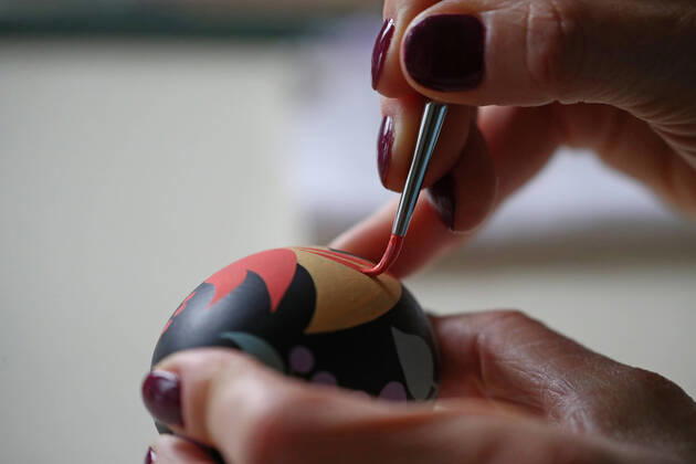 MOSCOW, RUSSIA - APRIL 16, 2020: Artist Iya Tokareva paints a wooden Easter egg Gorodets-style at her home studio; Gorodets painting, one of the traditional Russians handicrafts, originated in the middle of XIX century in the town of Gorodets, the Nizhny Novgorod Region. Anton Novoderezhkin TASS  TS0D5FF1