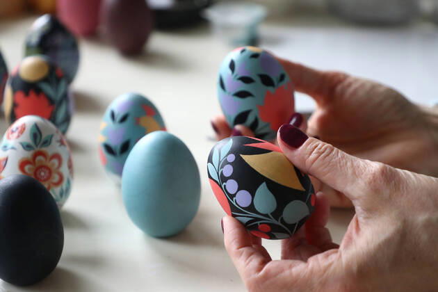 MOSCOW, RUSSIA - APRIL 16, 2020: Wooden Easter eggs painted Gorodets-style by Iya Tokareva at her home studio; Gorodets painting, one of the traditional Russians handicrafts, originated in the middle of XIX century in the town of Gorodets, the Nizhny Novgorod Region. Anton Novoderezhkin TASS  TS0D5FF2
