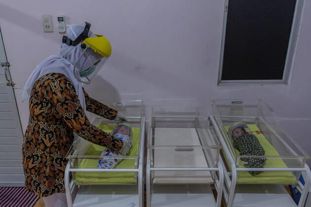 April 16, 2020, Bireuen, Aceh, Indonesia: A nurse wears a protective gear to put face shield on a newborn baby as a protective measure amid fears of coronavirus disease COVID-19 at a hospital in Bireuen, Aceh province. Latest reports of COVID-19 cases, Indonesian confirms 5.516 positive cases, 548 recovered with 496 deaths. Bireuen Indonesia - ZUMAm250 20200416_zip_m250_006 Copyright: xZikrixMaulanax