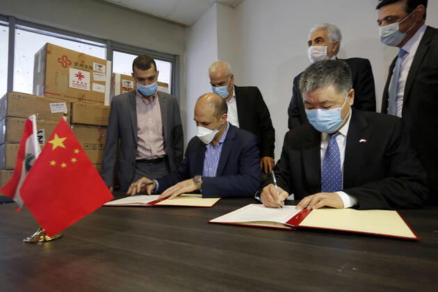 (200416) -- BEIRUT, April 16, 2020 (Xinhua) -- Chinese Ambassador to Lebanon Wang Kejian (R, front) and Lebanese Health Minister Hamad Hassan (L, front) sign at a handover ceremony of medical supplies donated by China in Beirut, Lebanon, April 16, 2020. TO GO WITH China donates testing kits, thermometers to help Lebanon fight COVID-19 . (Photo by Bilal Jawich Xinhua) LEBANON-COVID-19-CHINA-AID 