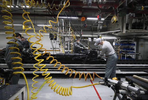 ULYANOVSK, RUSSIA - APRIL 16, 2020: Employees by the main conveyor in a shop at the UAZ Ulyanovsk Automobile Plant, a subsidiary of Sollers. UAZ has resumed operation since April 13 in compliance with sanitary regulations; according to a decree by the Ulyanovsk Region government, not more than 25% of the staff, engineering personnel, and office workers are to continue working remotely. Yegor Aleyev TASS  TS0D6051
