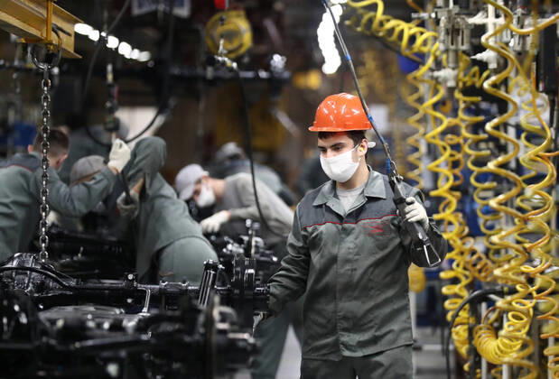 ULYANOVSK, RUSSIA - APRIL 16, 2020: Employees by the main conveyor in a shop at the UAZ Ulyanovsk Automobile Plant, a subsidiary of Sollers. UAZ has resumed operation since April 13 in compliance with sanitary regulations; according to a decree by the Ulyanovsk Region government, not more than 25% of the staff, engineering personnel, and office workers are to continue working remotely. Yegor Aleyev TASS  TS0D6053