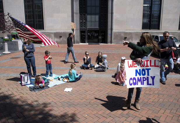 People with the group ReOpen Virginia hold a protest picnic calling on an end to the Virginia Stay at Home order put in place to limit the spread of COVID-19, on the grounds of the Virginia State Capitol in Richmond on Thursday, April 16, 2020. The group is calling for Gov. Ralph Northam to end Executive Order 53 with bans gathers of over 10. Photo Kevin Dietsch  WAP20200416303 KEVINxDIETSCH