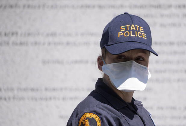 Police wear masks as they watch a protest organized by the group ReOpen Virginia calling on an end to the Virginia stay at home order put in place to limit the spread of COVID-19, on the grounds of the Virginia State Capitol in Richmond on Thursday, April 16, 2020. The group is calling for Gov. Ralph Northam to end Executive Order 53 with bans gathers of over 10. Photo Kevin Dietsch  WAP20200416313 KEVINxDIETSCH