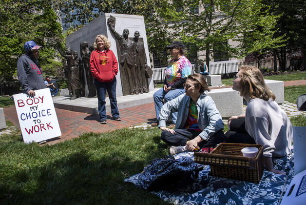 People with the group ReOpen Virginia hold a protest picnic calling on an end to the Virginia Stay at Home order put in place to limit the spread of COVID-19, on the grounds of the Virginia State Capitol in Richmond on Thursday, April 16, 2020. The group is calling for Gov. Ralph Northam to end Executive Order 53 with bans gathers of over 10. Photo Kevin Dietsch  WAP20200416304 KEVINxDIETSCH
