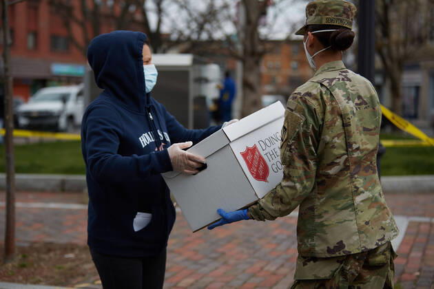 April 16, 2020, Chelsea, Massachusetts, US: The Massachusetts National Guard has responded to the COVID-19, Corona Virus, situation in Chelsea, Massachusetts. Chelsea is a major hot spot, and the hardest hit city in the state. Chelsea is a Latin American immigrant heavy population with 80% of the population being essential workers, such as grocery clerks. The National Guard hands out food to local residents with donations from the Salvation Army. Chelsea US - ZUMAd211 20200416_zap_d211_004 Copyright: xAllisonxDinnerx