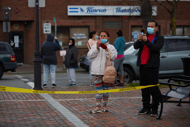 April 16, 2020, Chelsea, Massachusetts, US: The Massachusetts National Guard has responded to the COVID-19, Corona Virus, situation in Chelsea, Massachusetts. Chelsea is a major hot spot, and the hardest hit city in the state. Chelsea is a Latin American immigrant heavy population with 80% of the population being essential workers, such as grocery clerks. The National Guard hands out food to local residents with donations from the Salvation Army. Chelsea US - ZUMAd211 20200416_zap_d211_012 Copyright: xAllisonxDinnerx