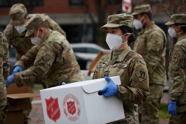 April 16, 2020, Chelsea, Massachusetts, US: The Massachusetts National Guard has responded to the COVID-19, Corona Virus, situation in Chelsea, Massachusetts. Chelsea is a major hot spot, and the hardest hit city in the state. Chelsea is a Latin American immigrant heavy population with 80% of the population being essential workers, such as grocery clerks. The National Guard hands out food to local residents with donations from the Salvation Army. Chelsea US - ZUMAd211 20200416_zap_d211_021 Copyright: xAllisonxDinnerx