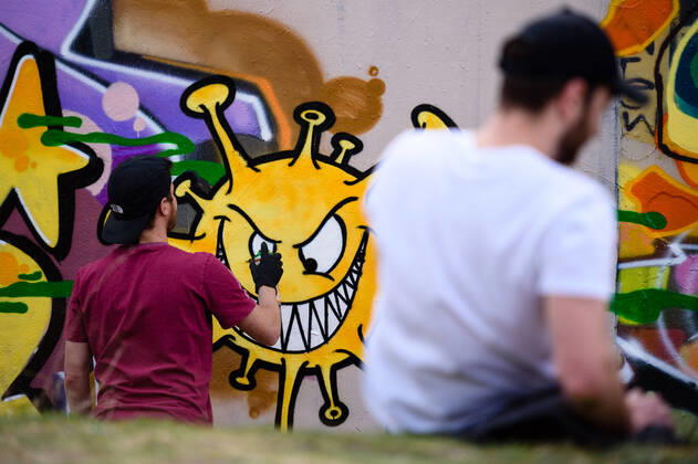 April 16, 2020: Graffiti artists spray a picture in the form of a corona virus on a wall in Berlin s Gleisdreieckpark. People living in the city of Berlin have to stay in their flats or usual accommodation to contain the coronavirus, meetings of more than 2 persons are forbidden, people are asked to keep a minimum distance. - ZUMAs172 20200416_zap_s172_008 Copyright: xJanxScheunertx