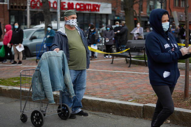 April 16, 2020, Chelsea, Massachusetts, US: The Massachusetts National Guard has responded to the COVID-19, Corona Virus, situation in Chelsea, Massachusetts. Chelsea is a major hot spot, and the hardest hit city in the state. Chelsea is a Latin American immigrant heavy population with 80% of the population being essential workers, such as grocery clerks. The National Guard hands out food to local residents with donations from the Salvation Army. Chelsea US - ZUMAd211 20200416_zap_d211_001 Copyright: xAllisonxDinnerx