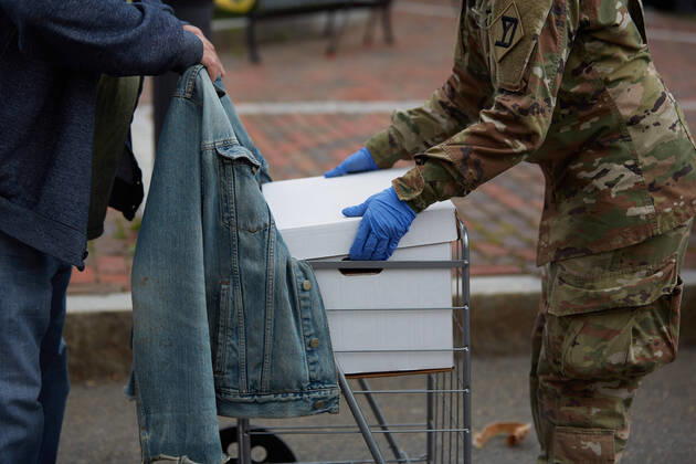 April 16, 2020, Chelsea, Massachusetts, US: The Massachusetts National Guard has responded to the COVID-19, Corona Virus, situation in Chelsea, Massachusetts. Chelsea is a major hot spot, and the hardest hit city in the state. Chelsea is a Latin American immigrant heavy population with 80% of the population being essential workers, such as grocery clerks. The National Guard hands out food to local residents with donations from the Salvation Army. Chelsea US - ZUMAd211 20200416_zap_d211_019 Copyright: xAllisonxDinnerx