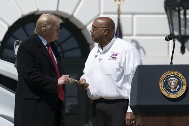 President Donald Trump presents a ceremonial key to driver Stephen Richardson of the American Trucking Association during an event celebrating America s Truckers on the South Lawn of the White House in Washington, DC on Thursday, April 16, 2020. Trunks have stayed on the road to bring the necessary goods to the public during the Covid-19 stay at home orders.  WAX20200416115 ChrisxKleponis