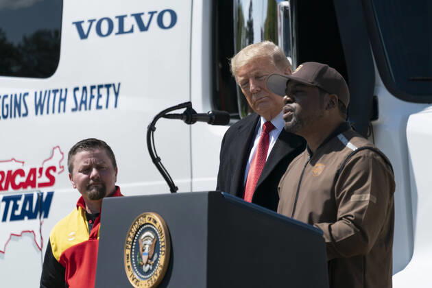 President Donald Trump listens as UPS truck driver Charlton Paul speaks during an event celebrating America s Truckers on the South Lawn of the White House in Washington, DC on Thursday, April 16, 2020. Trunks have stayed on the road to bring the necessary goods to the public during the Covid-19 stay at home orders.  WAX20200416119 ChrisxKleponis
