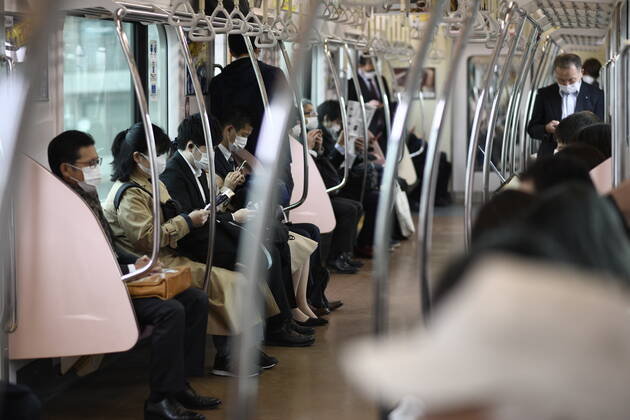 TOKYO, JAPAN - APRIL 17: Commuters wearing face mask head to work early morning inside of JR Yamanote train in Tokyo on Friday, April 17, 2020. The Japanese government decided to expand the current areas under a state of emergency to nationwide, as the Covid-19 coronavirus outbreak continues to spread throughout the country. (Photo: Richard Atrero de Guzman AFLO) (125423237)
