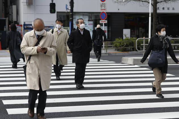 TOKYO, JAPAN - APRIL 17: Commuters wearing face mask head to work early morning in Shinjuku, Tokyo on Friday, April 17, 2020. The Japanese government decided to expand the current areas under a state of emergency to nationwide, as the Covid-19 coronavirus outbreak continues to spread throughout the country. (Photo: Richard Atrero de Guzman AFLO) (125423269)